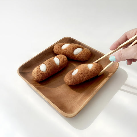 Felt baguette handled with tongs