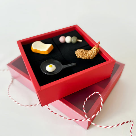 4 utility rests posed on a red box with black padding